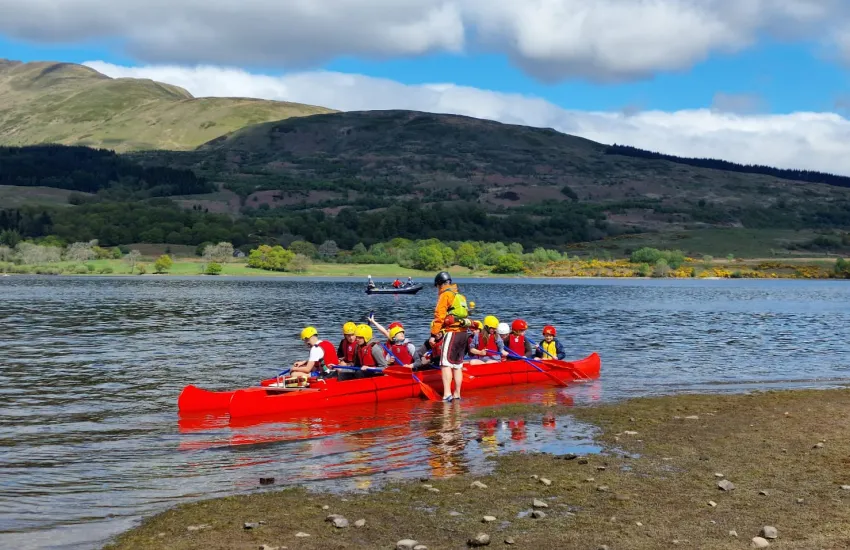 scouts in a canoe on a loch