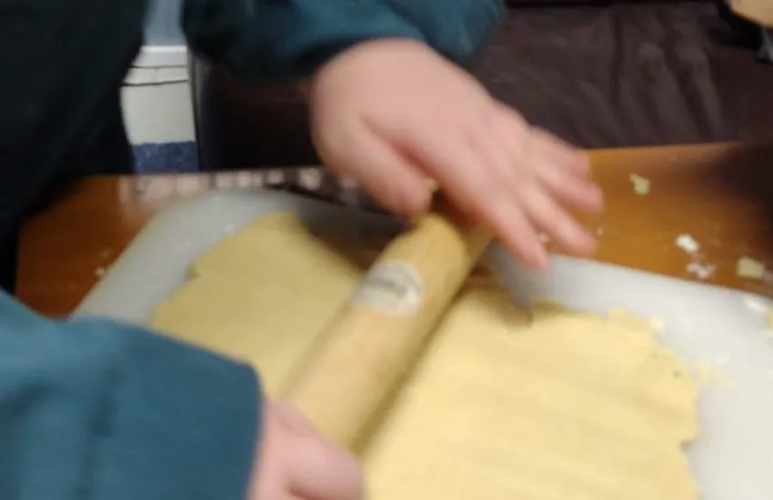 A scout rolling out shortbread