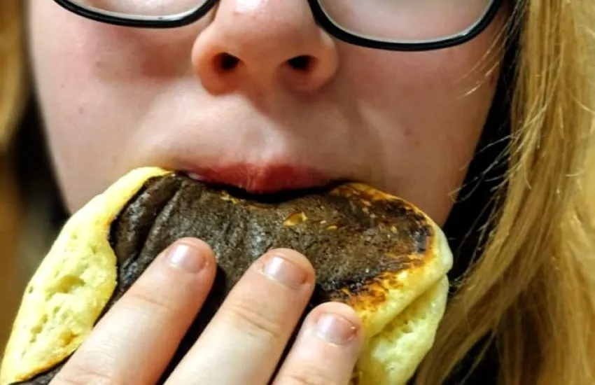 A scout eating a pancake 