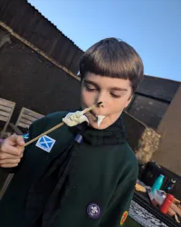 A cub eating toasted marshmallow
