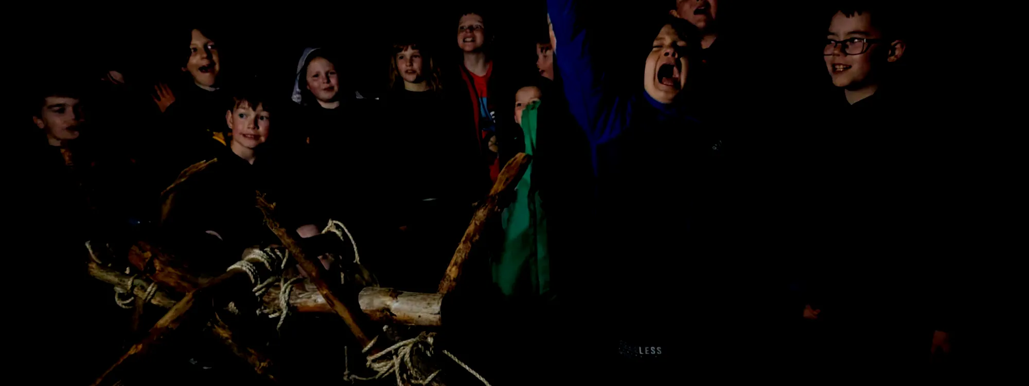 Scouts posing behind a bushcraft trebuchet